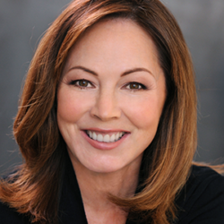Smiling woman with shoulder-length brown hair, wearing a black top, against a gray background—perfect for discussions like How to Inform the Public as an Information Gatekeeper During a Disaster with Sydnie Kohara.