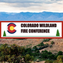 Colorado Wildland Fire Conference sign with mountains, trees, and a cloudy sky in the background highlights the scenic setting of this Colorado Conference.