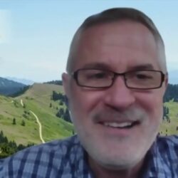A smiling man with glasses, possibly Jim White, sits in front of a scenic mountain landscape, with a logo and rebuild permit in the top left corner.