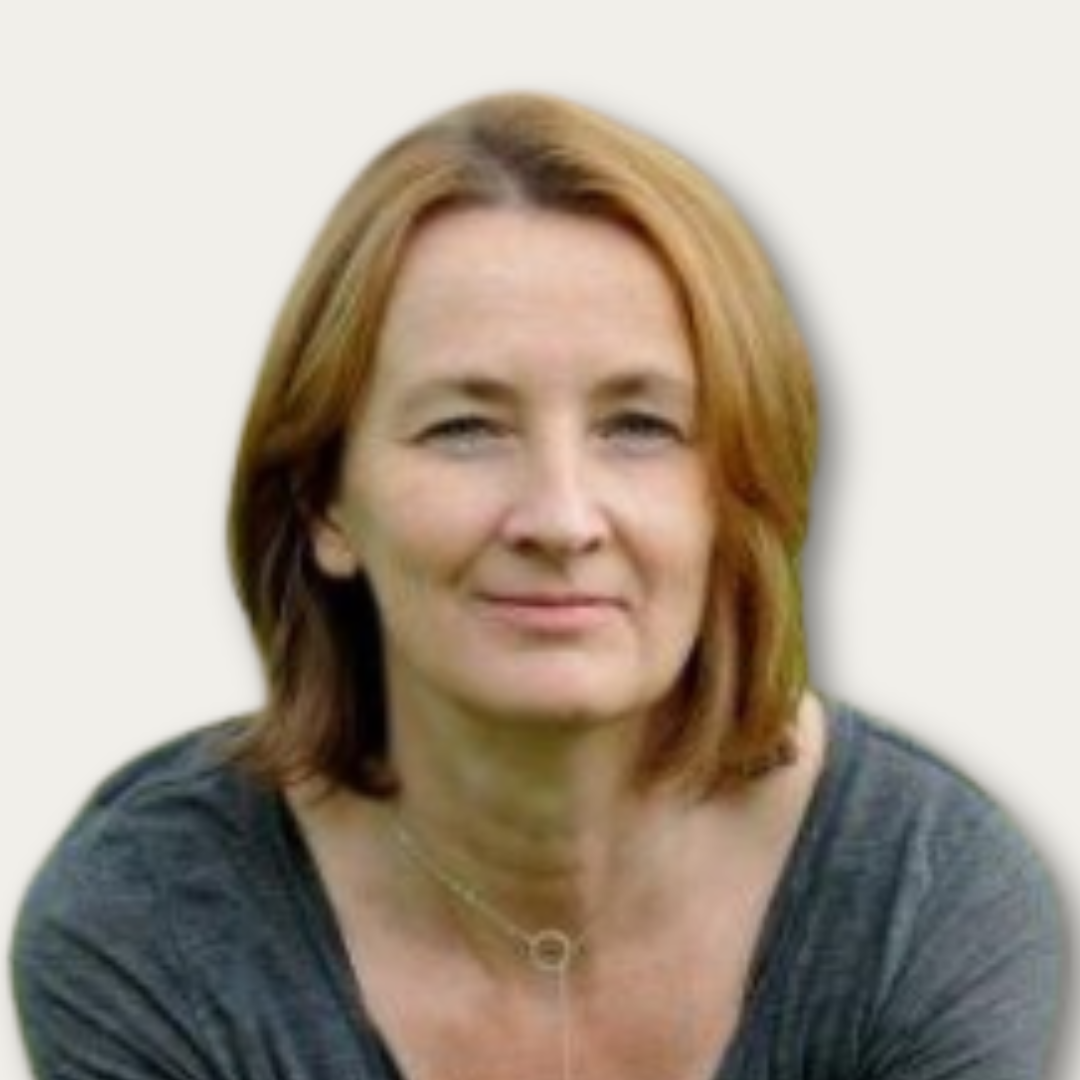 Woman with short brown hair wearing a gray top and silver necklace, looking at the camera with a neutral expression.