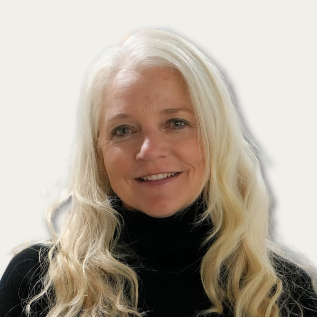 Woman with long blonde hair wearing a black turtleneck, smiling at the camera against a plain background.